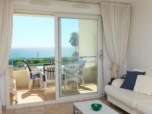 a living room with a view of the ocean at Apartment Le Grand Large by Interhome in Juan-les-Pins