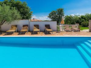 a group of chairs and a swimming pool at Holiday Home Ksenija-1 by Interhome in Čepljani