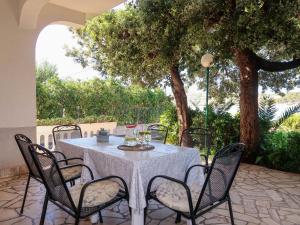 a table and chairs on a patio with a tree at Apartment Noa by Interhome in Rab +27 photos