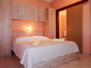 a bedroom with a large bed in a room at Apartment Noa by Interhome in Rab