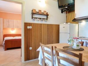 a kitchen and dining room with a table and a refrigerator at Apartment Noa by Interhome in Rab