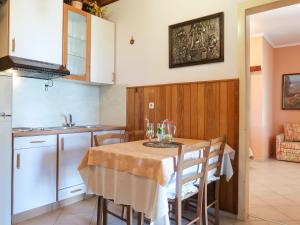 a kitchen with a table with wine glasses on it at Apartment Noa by Interhome in Rab