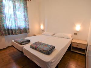 En eller flere senger på et rom på Apartment Elettra-3 by Interhome