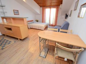 a room with a table and a bed and a bedroom at Apartment Šarić-1 by Interhome in Trogir
