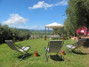 two chairs and a gazebo in a yard at Holiday Home Podere Conte Francesco-Carla by Interhome in Certaldo