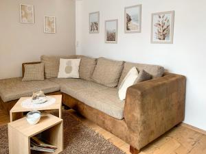a living room with a couch and a table at Holiday Home Vosshörn by Interhome in Westerschoo