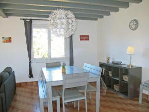 a dining room with a table and a chandelier at Holiday Home El Réfugio by Interhome in Mimizan-Plage