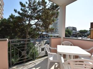 a balcony with a table and chairs and a tree at Apartment Doria Uno by Interhome in Lido degli Estensi