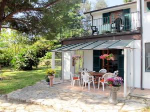 a patio with a table and chairs and a balcony at Holiday Home Villa La Vigna - TAZ175 by Interhome in Torrazza