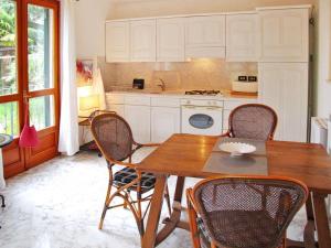 a kitchen with a wooden table and chairs at Holiday Home Villa La Vigna - TAZ175 by Interhome in Torrazza