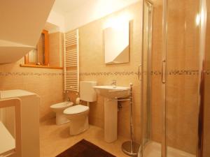 a bathroom with a toilet and a sink and a shower at Holiday Home Albergo Diffuso - Cjasa Marisa by Interhome in Barcis