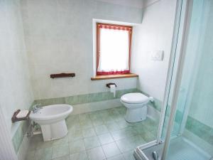 a bathroom with a toilet and a sink at Apartment Albergo Diffuso - Cjasa Fantin by Interhome in Barcis +17 photos