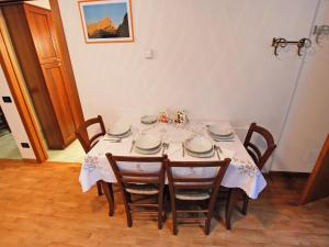 a dining room table with a white table cloth at Apartment Albergo Diffuso - Cjasa Fantin by Interhome in Barcis