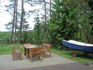 a table and chairs and a table and a boat at Holiday Home Mielno 1 by Interhome in Mielno