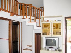 a living room with a staircase and a tv at Apartment Reale Marina - REI209 by Interhome in Costa Rei