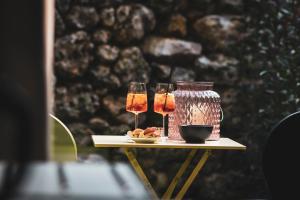a table with two wine glasses and a jar at San Valentino Hotel in Villa di Serio