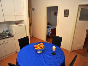 a blue table with a bowl of fruit on it at Apartment Mirta-2 by Interhome in Sutivan