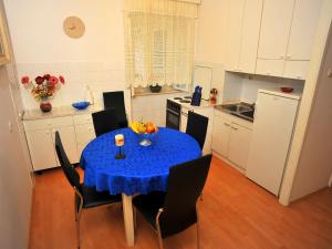 a kitchen with a table with a blue table cloth on it at Apartment Mirta-2 by Interhome in Sutivan