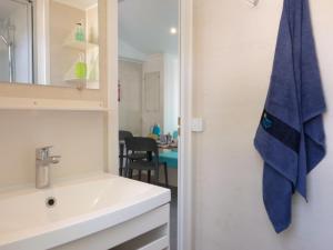 a bathroom with a sink and a mirror at Holiday Home Camping Laguna Village-1 by Interhome in Porto Falconera