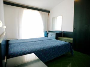 a small bedroom with a bed and a window at Apartment Costa di Kair ed Din-6 by Interhome in Sperlonga
