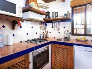 a kitchen with a sink and a stove top oven at Holiday Home La Cordobilla - AMU172 by Interhome in Almuñécar