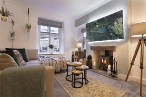 a living room with a couch and a fireplace at Rosie's Escape with Hot Tub in Barrowford