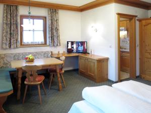 pokój z łóżkiem, stołem i telewizorem w obiekcie Apartment Gredler-2 by Interhome w Mayrhofen