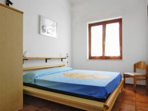 Un pat sau paturi într-o cameră la Apartment Reale Marina - REI207 by Interhome