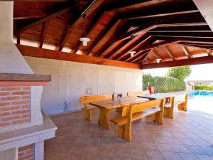 a large wooden table in a patio with benches at Villa Old School House by Interhome in Bašići