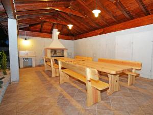 a dining room with a large wooden table and benches at Villa Old School House by Interhome in Bašići