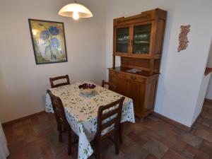 a dining room with a table and a cabinet at Holiday Home La Corte Bricca - Trilo Torretta by Interhome in Castana +20 photos