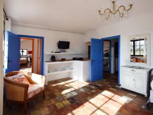 a living room with blue doors and a kitchen at Apartment Villa Vivendi - VEN106 by Interhome in Vence