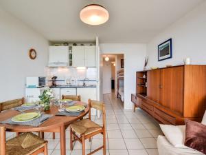 a dining room and kitchen with a table and chairs at Apartment Grands espaces by Interhome in Mimizan-Plage