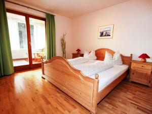 a bedroom with a wooden bed in a room at Apartment Schwarzwald 6 EG by Interhome in Radenthein