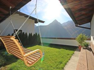 a swing on a porch with a view of a mountain at Holiday Home Berghof Reich by Interhome in Längenfeld