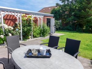 a table with a tray of food on top of it at Holiday Home Adda by Interhome in Neßmersiel