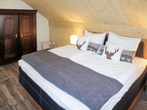 a bedroom with a large bed with antlers on it at Apartment Schmalzenhof by Interhome in Hofstetten