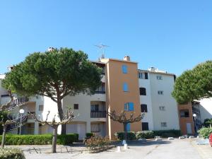 a building with trees in front of it at Apartment Camargue Village-2 by Interhome in Le Grau-du-Roi