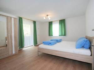 A bed or beds in a room at Apartment Alpenrose-2 by Interhome