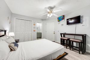 a bedroom with a bed and a ceiling fan at The Inn at St. Thomas Square #1203A in Panama City Beach