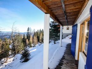 a porch of a house with snow on the ground at Chalet Willegger by Interhome in Hochrindl