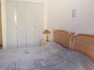 a bedroom with a bed and a table with a lamp at Apartment Le Concordia by Interhome in Nice