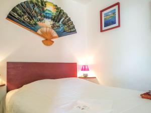 a bedroom with a bed and a painting on the wall at Apartment Hego Alde by Interhome in Bidart +15 photos