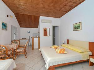 a bedroom with two beds and a table and chairs at Apartment Martina by Interhome in Selca kod Bogomolja