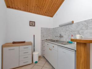 a kitchen with a sink and a counter top at Apartment Martina by Interhome in Selca kod Bogomolja +10 photos