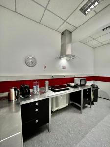 a large kitchen with a counter in a room at Pension Messe in Feldkirchen