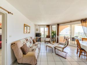 a living room with a couch and a table at Apartment Bleu Marine-5 by Interhome in Fréjus