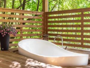 a bath tub sitting on a deck next to a fence at Holiday Home Klen 2 by Interhome in Hreljići