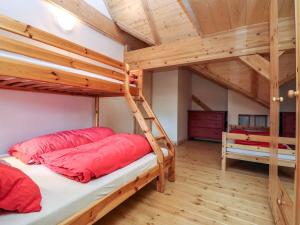 two bunk beds in a room with wooden ceilings at Apartment Bärenhöhle - Top 6 by Interhome in Grünau im Almtal