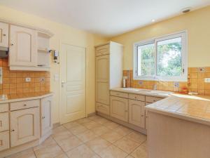 a large kitchen with a sink and a window at Holiday Home Maison Les Hortensias by Interhome in Pleurtuit